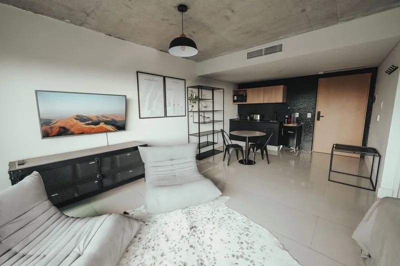 Premium interior with lounge chairs, dining table and kitchen
