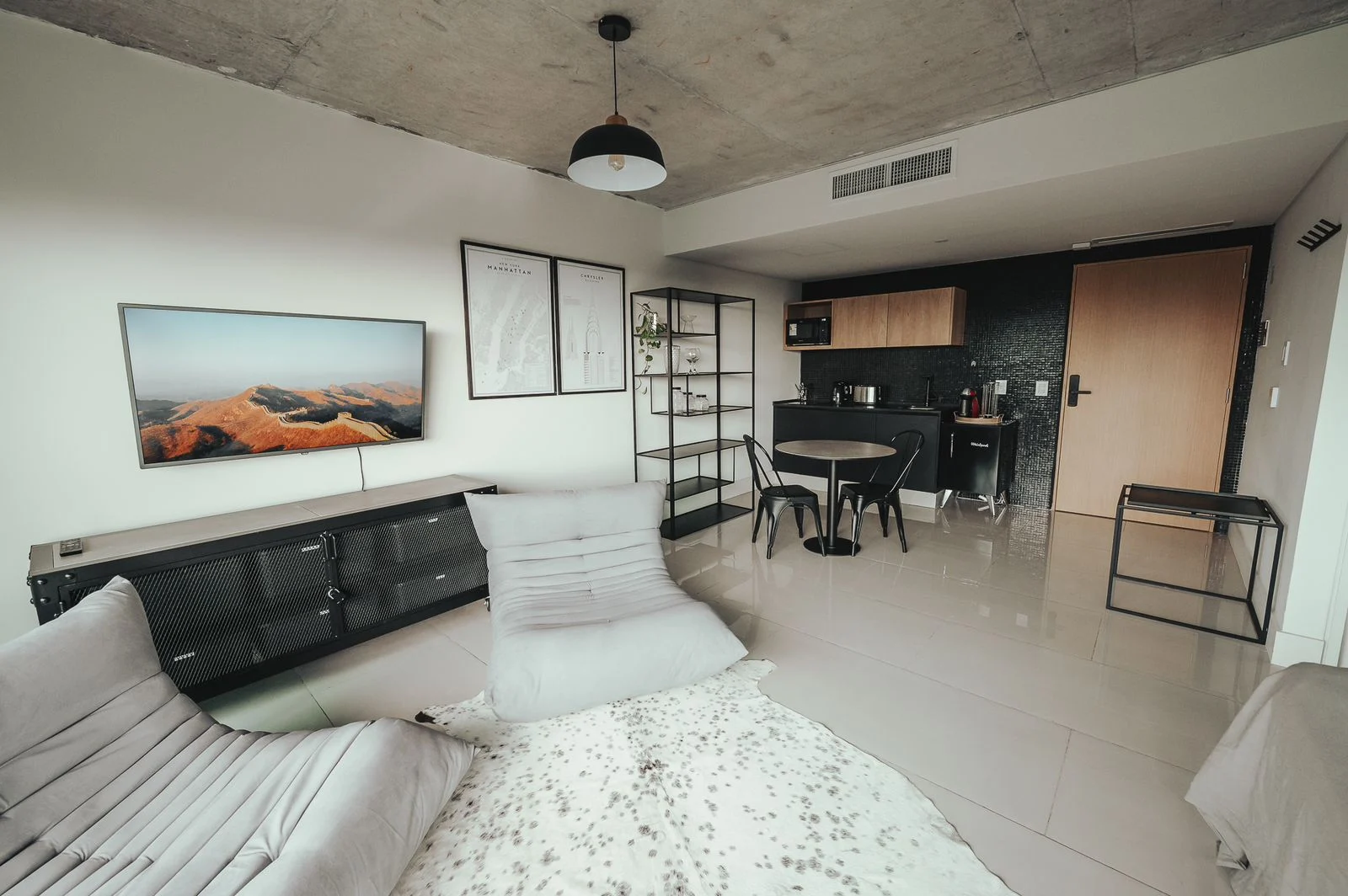 Premium interior with lounge chairs, dining table and kitchen